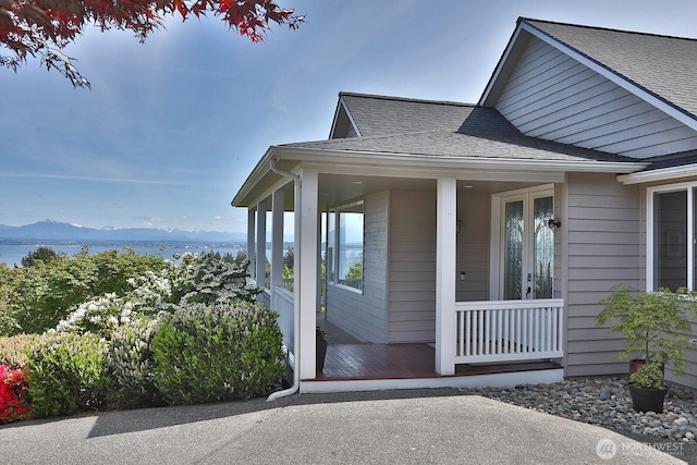 4638 Tanner View Dr, Clinton, WA 98236 - property entrance with a shingled roof, french doors, covered porch, and a mountain view