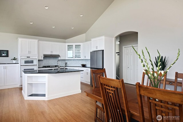 4638 Tanner View Dr, Clinton, WA 98236 - kitchen featuring open shelves, under cabinet range hood, tasteful backsplash, white cabinets, and dark countertops