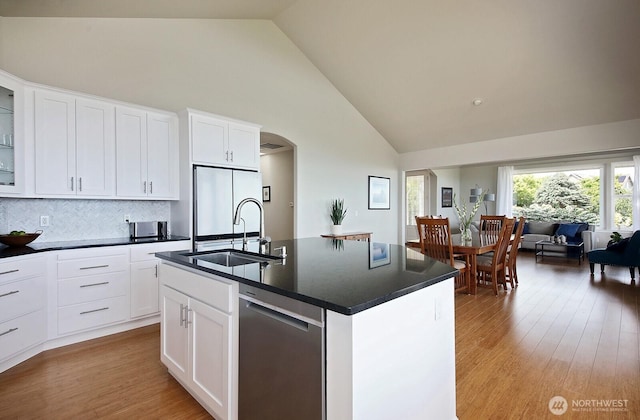 4638 Tanner View Dr, Clinton, WA 98236 - kitchen with a sink, white refrigerator, dark countertops, high vaulted ceiling, and dishwasher