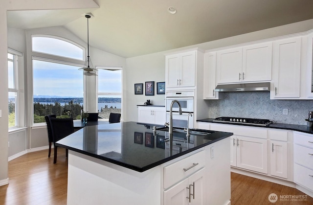 4638 Tanner View Dr, Clinton, WA 98236 - kitchen featuring a sink, vaulted ceiling, wood finished floors, decorative backsplash, and stainless steel gas stovetop