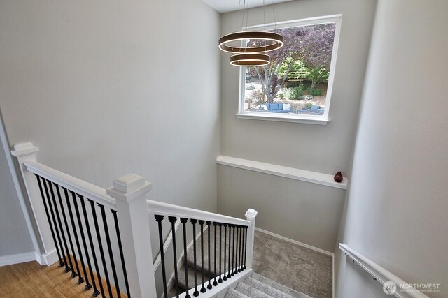 4638 Tanner View Dr, Clinton, WA 98236 - staircase featuring a chandelier, baseboards, and carpet
