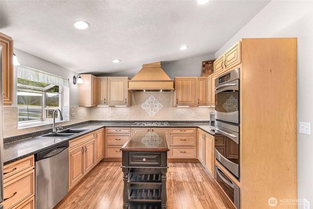 846 Deep Valley Dr, Maple Falls, WA 98266 - kitchen with stainless steel appliances, a sink, a warming drawer, light wood-style flooring, and a textured ceiling