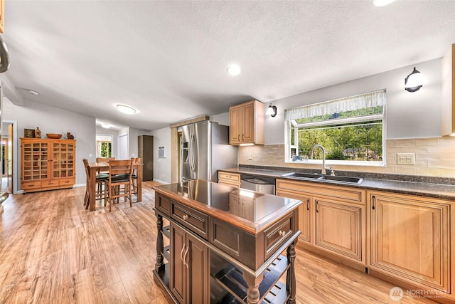 846 Deep Valley Dr, Maple Falls, WA 98266 - kitchen featuring a sink, appliances with stainless steel finishes, dark countertops, backsplash, and a textured ceiling