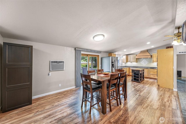 846 Deep Valley Dr, Maple Falls, WA 98266 - dining room featuring light wood finished floors, baseboards, a textured ceiling, a wall unit AC, and a ceiling fan