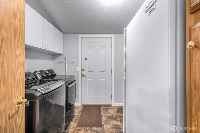 846 Deep Valley Dr, Maple Falls, WA 98266 - laundry room featuring cabinet space, washer and clothes dryer, a textured ceiling, dark stone finish flooring, and baseboards