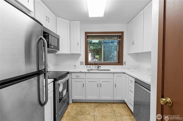 12840 SE 40th Ct Unit B2, Bellevue, WA 98006 - kitchen featuring appliances with stainless steel finishes, a sink, white cabinetry, and light stone counters