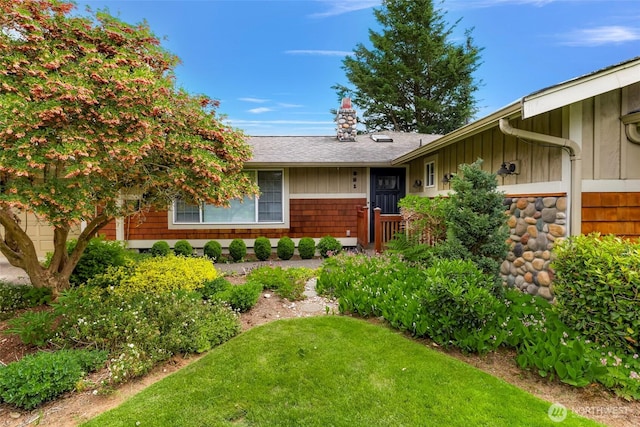 321 Park Pl, Lynden, WA 98264 - doorway to property with board and batten siding, a lawn, and roof with shingles