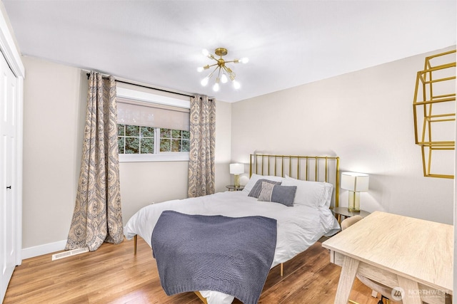 321 Park Pl, Lynden, WA 98264 - bedroom featuring wood finished floors, a chandelier, baseboards, and a closet