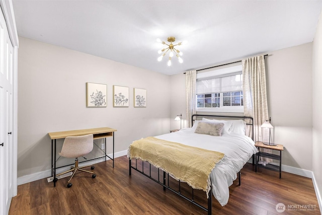 321 Park Pl, Lynden, WA 98264 - bedroom with baseboards, wood finished floors, and a chandelier