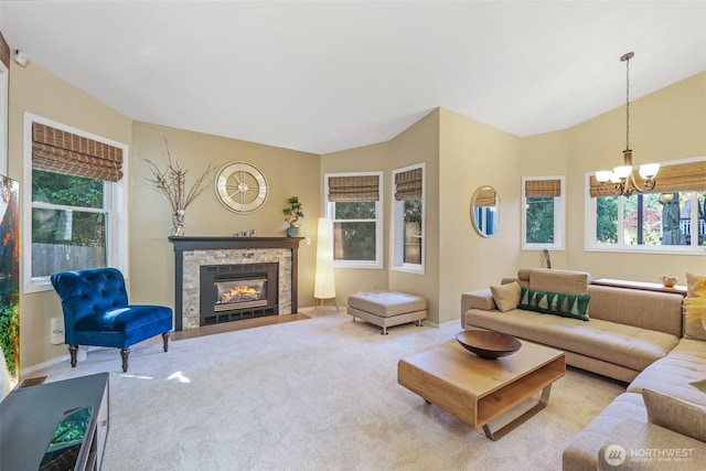 carpeted living area with a chandelier, a fireplace, and lofted ceiling