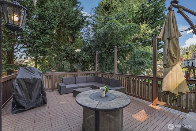 wooden deck with an outdoor living space and grilling area