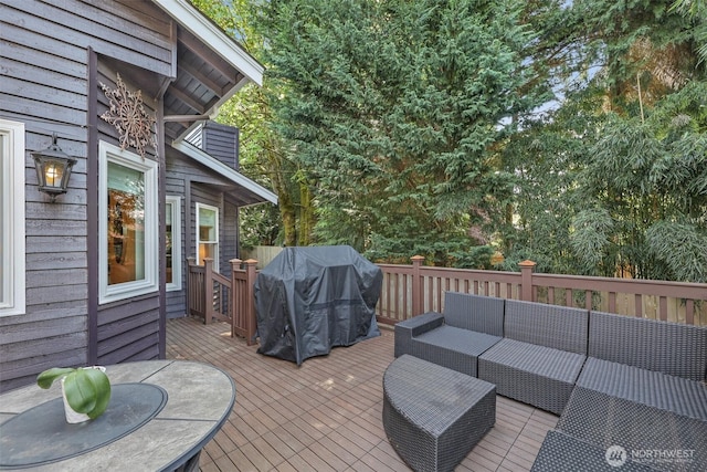wooden deck featuring outdoor lounge area and a grill