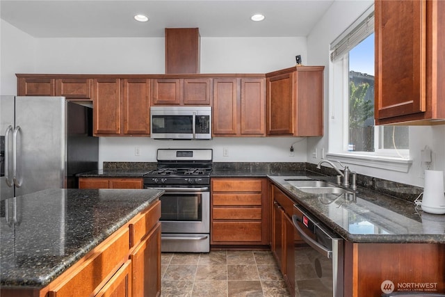 1339 E 51st St, Tacoma, WA 98404 - kitchen with stainless steel appliances, a sink, dark stone countertops, stone finish floors, and recessed lighting
