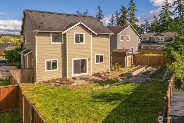 1339 E 51st St, Tacoma, WA 98404 - back of property with a storage shed, a vegetable garden, an outdoor structure, roof with shingles, and a patio area