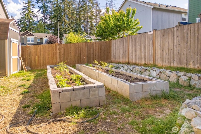 1339 E 51st St, Tacoma, WA 98404 - fenced backyard with a vegetable garden, a storage unit, and an outbuilding
