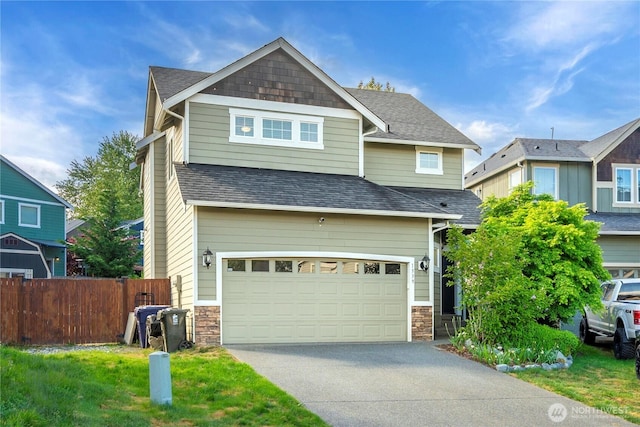 1339 E 51st St, Tacoma, WA 98404 - craftsman inspired home featuring fence, driveway, an attached garage, a shingled roof, and stone siding