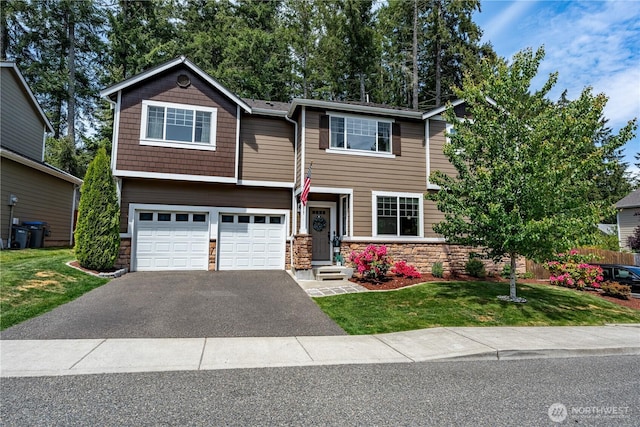 3677 SE Chesterton Dr, Port Orchard, WA 98366 - view of front facade with asphalt driveway, stone siding, an attached garage, and a front lawn