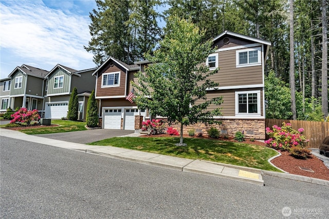 3677 SE Chesterton Dr, Port Orchard, WA 98366 - view of front facade with stone siding, driveway, and a garage