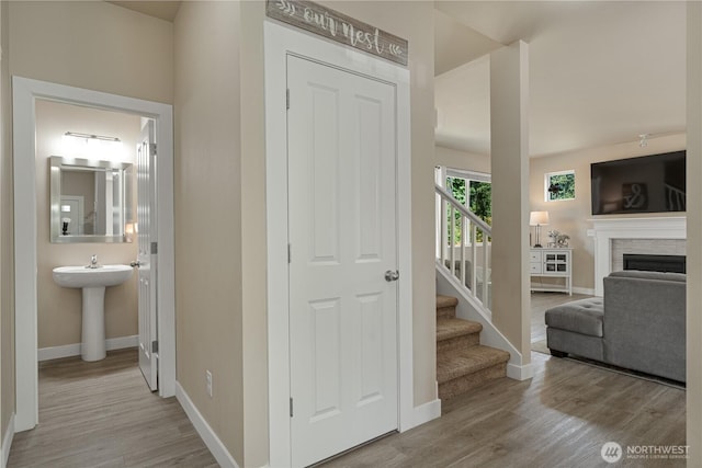 3677 SE Chesterton Dr, Port Orchard, WA 98366 - hall featuring wood finished floors, baseboards, stairway, and a sink