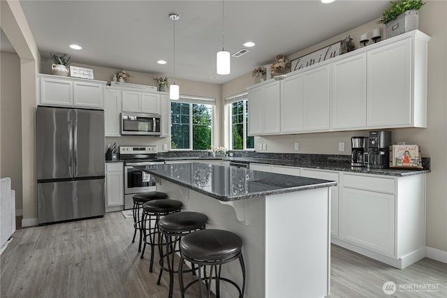 3677 SE Chesterton Dr, Port Orchard, WA 98366 - kitchen featuring stainless steel appliances, light wood finished floors, white cabinetry, a center island, and recessed lighting