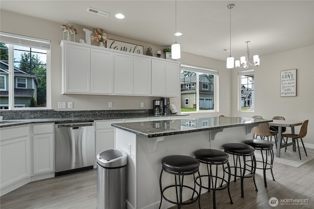 3677 SE Chesterton Dr, Port Orchard, WA 98366 - kitchen with stainless steel dishwasher, light wood-style flooring, white cabinetry, and recessed lighting