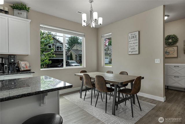 3677 SE Chesterton Dr, Port Orchard, WA 98366 - dining area with a chandelier, baseboards, and light wood-style floors