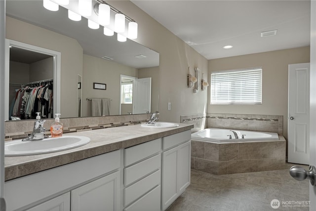 3677 SE Chesterton Dr, Port Orchard, WA 98366 - full bath featuring double vanity, a bath, tile patterned floors, and a spacious closet