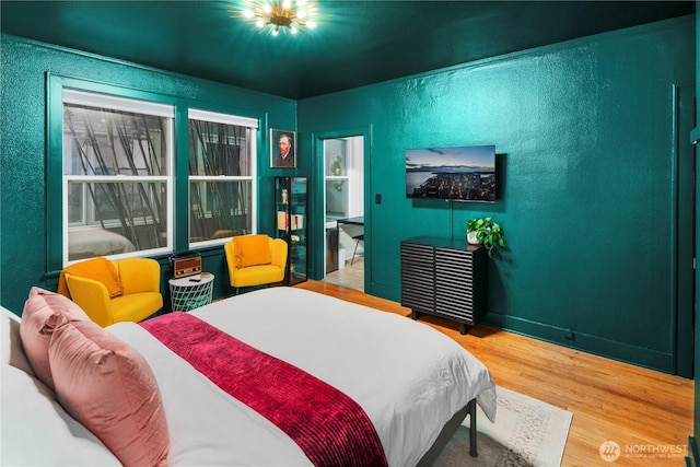 905 NE 43rd Ave Unit 110, Seattle, WA 98105 - bedroom featuring wood finished floors and a textured wall