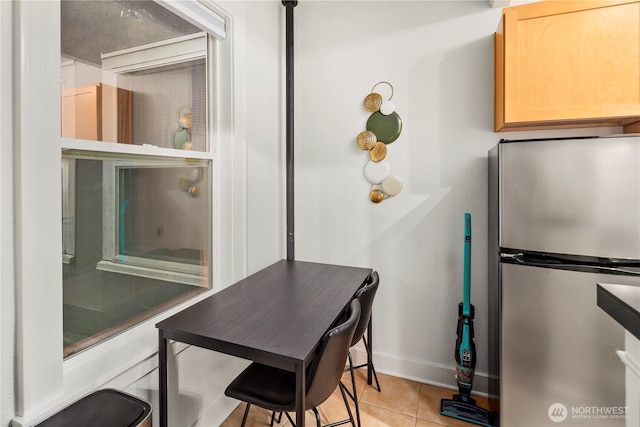 905 NE 43rd Ave Unit 110, Seattle, WA 98105 - dining area featuring baseboards and light tile patterned flooring