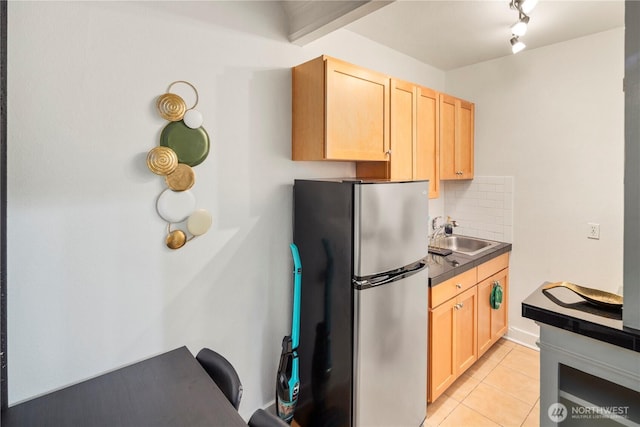 905 NE 43rd Ave Unit 110, Seattle, WA 98105 - kitchen featuring freestanding refrigerator, a sink, light brown cabinets, light tile patterned floors, and backsplash