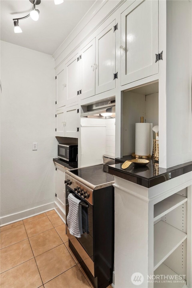 905 NE 43rd Ave Unit 110, Seattle, WA 98105 - kitchen featuring stainless steel electric range, white cabinets, dark countertops, baseboards, and light tile patterned floors