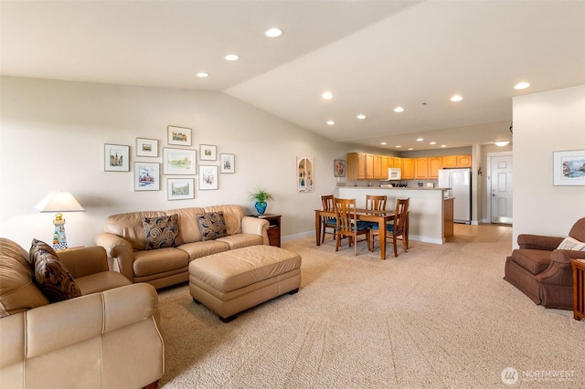living room with lofted ceiling, recessed lighting, light colored carpet, and baseboards