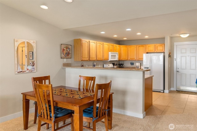 dining area featuring baseboards and recessed lighting