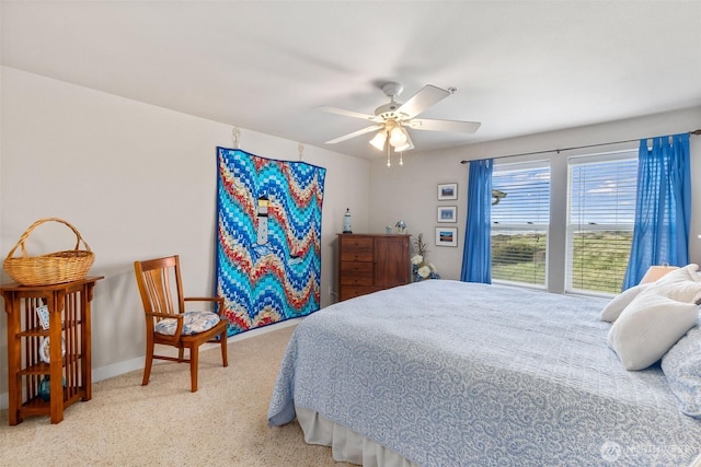 carpeted bedroom with baseboards and ceiling fan