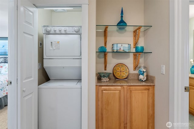 laundry room with estacked washer and dryer