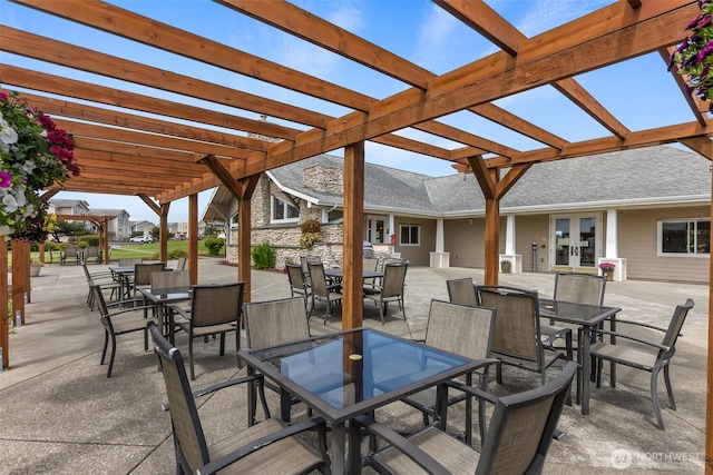 view of patio / terrace featuring outdoor dining area, a pergola, and french doors