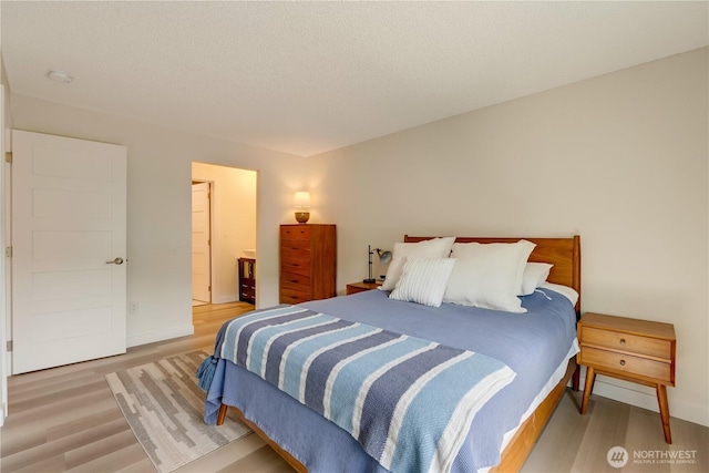 bedroom featuring light wood-type flooring and baseboards