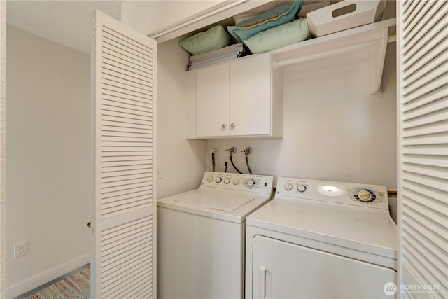 washroom with cabinet space and washer and clothes dryer