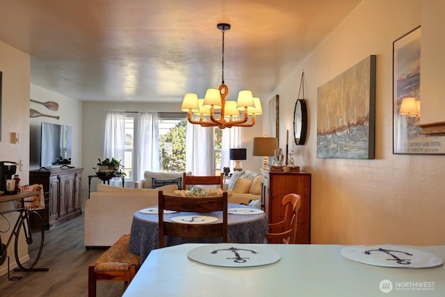 1515 Ocean Beach Blvd Unit 202, Long Beach, WA 98631 - dining area featuring a chandelier and dark wood-style flooring