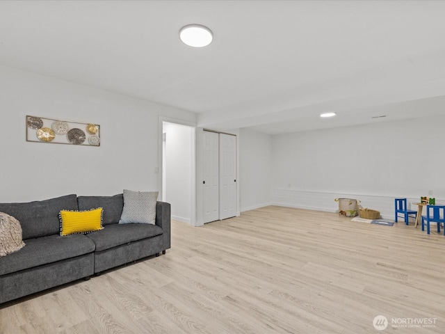 living area featuring wood finished floors and baseboards