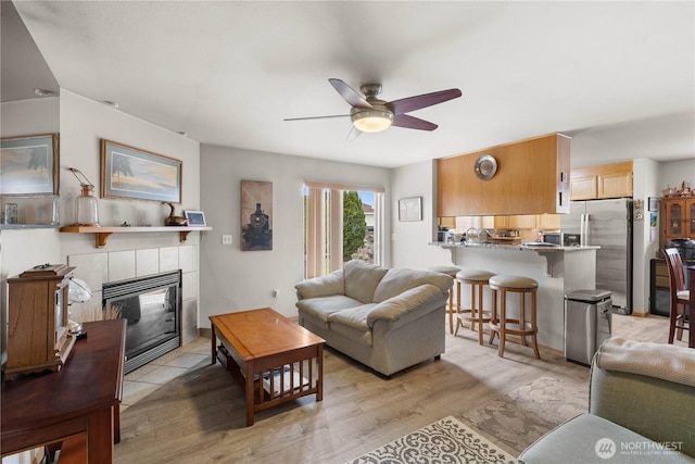 336 Spring Cir SW, Mattawa, WA 99349 - living area with a ceiling fan, light wood-style floors, and a fireplace