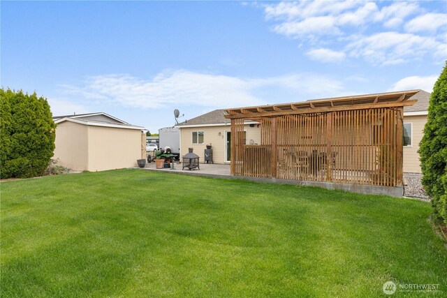 336 Spring Cir SW, Mattawa, WA 99349 - rear view of house featuring a yard, a patio area, and an outbuilding