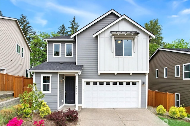 4933 Wanderlust Way, Gig Harbor, WA 98332 - view of front of home with fence, board and batten siding, driveway, and an attached garage
