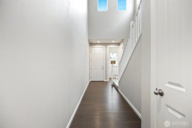 4933 Wanderlust Way, Gig Harbor, WA 98332 - corridor with baseboards, a towering ceiling, dark wood-style flooring, stairway, and recessed lighting