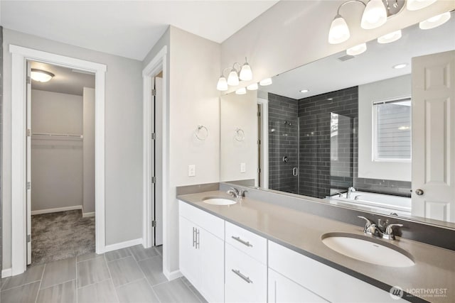 4933 Wanderlust Way, Gig Harbor, WA 98332 - full bathroom with a stall shower, a spacious closet, double vanity, baseboards, and a garden tub