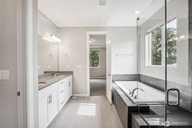 4933 Wanderlust Way, Gig Harbor, WA 98332 - bathroom featuring double vanity, a bath, and baseboards
