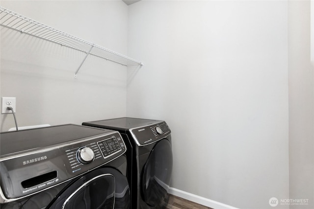 4933 Wanderlust Way, Gig Harbor, WA 98332 - laundry room featuring washer and clothes dryer, baseboards, and wood finished floors