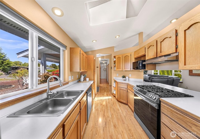 8224 Quinault Rd, Blaine, WA 98230 - kitchen with stainless steel appliances, a sink, under cabinet range hood, light countertops, and light wood finished floors