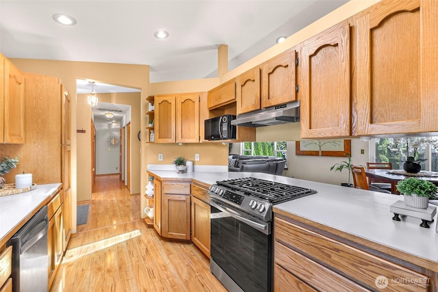 8224 Quinault Rd, Blaine, WA 98230 - kitchen with appliances with stainless steel finishes, under cabinet range hood, light countertops, light wood finished floors, and recessed lighting