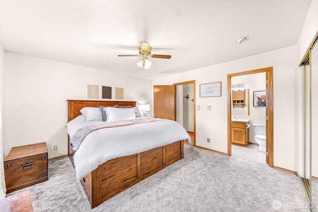 8224 Quinault Rd, Blaine, WA 98230 - bedroom featuring light colored carpet, baseboards, connected bathroom, ceiling fan, and a closet